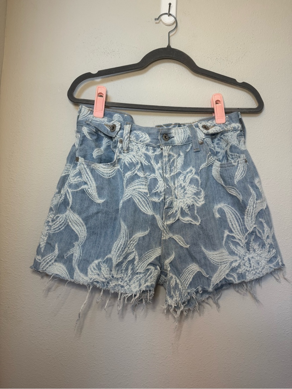 Levi's Women's Cinched Tab denim shorts with an embroidered floral design